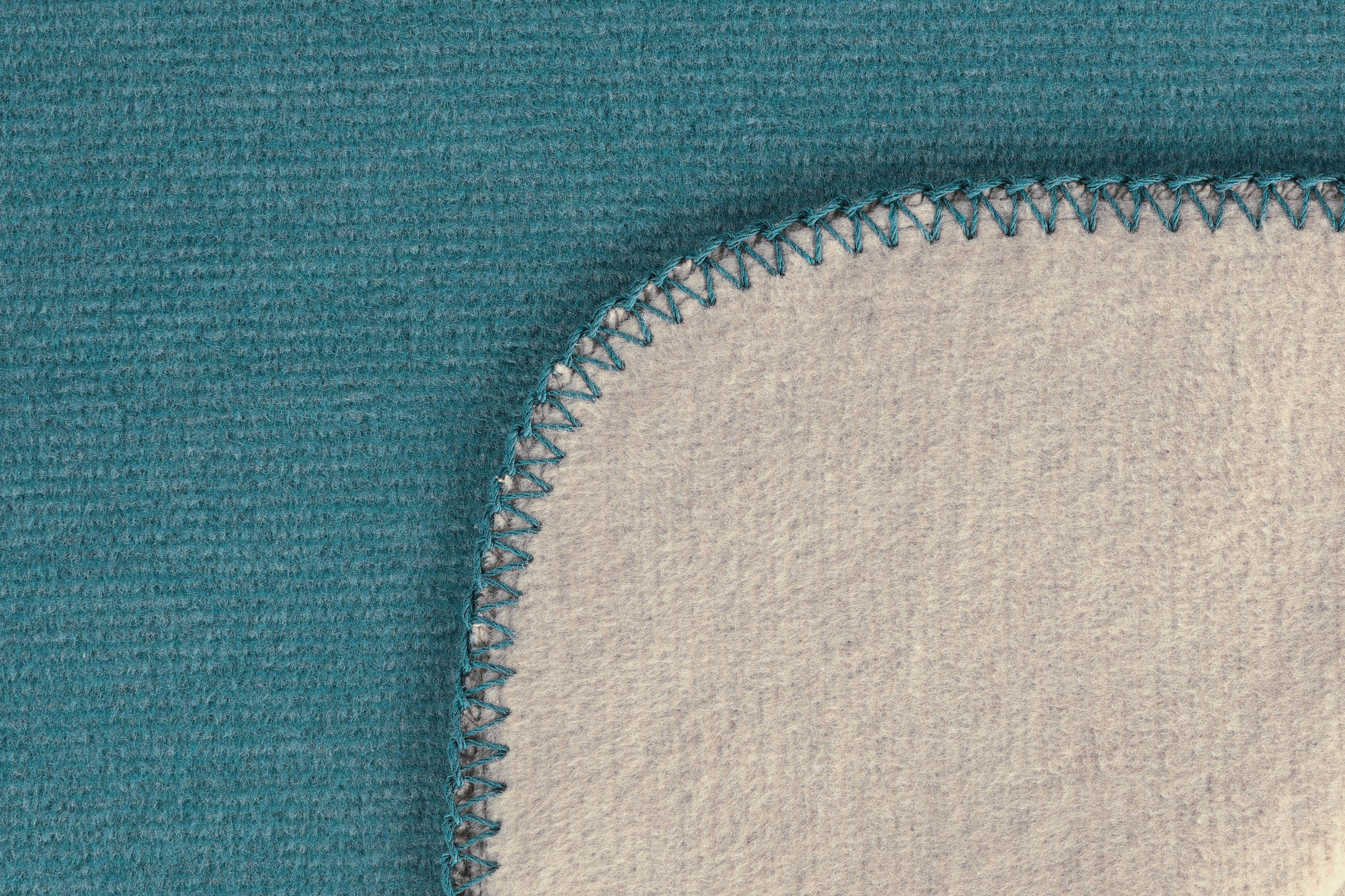 Wohndecke Duo Cotton Melange teal-stone Nahaufnahme Einfassung